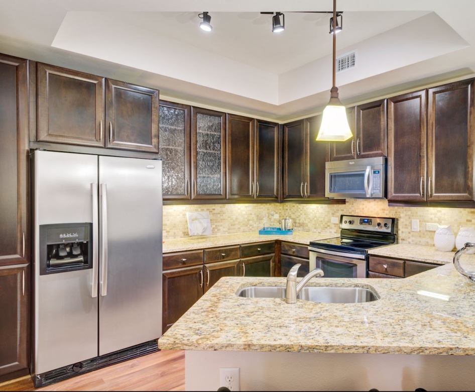 Large well lit kitchen with wood floors 